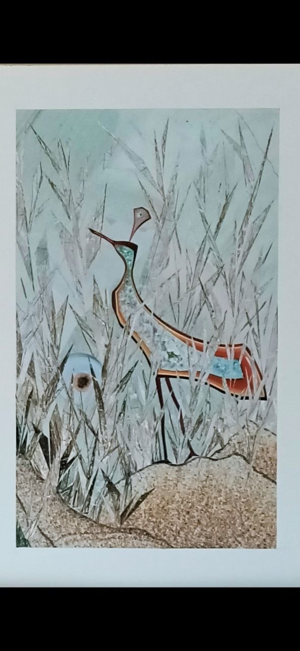 A slender bird stands among pale winter reeds.